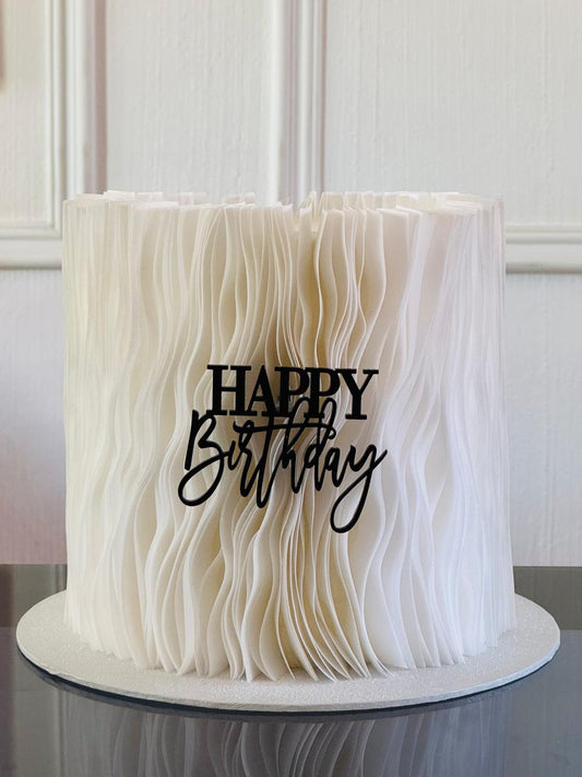 Close-up of a frilled, edible garnish on a gourmet dish, highlighting its texture and culinary appeal