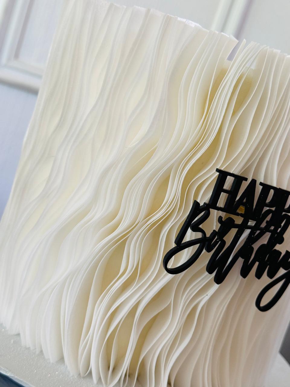 Close-up of a frilled, edible garnish on a gourmet dish, highlighting its texture and culinary appeal