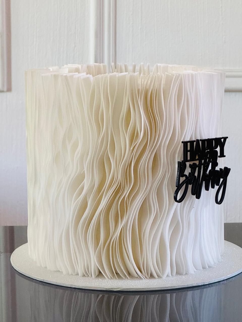 Close-up of a frilled, edible garnish on a gourmet dish, highlighting its texture and culinary appeal